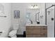 Modern bathroom with a walk-in shower and wood vanity at 3553 W 63Rd Ave, Denver, CO 80221