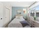 Light and airy bedroom with a queen-size bed and light blue walls at 3553 W 63Rd Ave, Denver, CO 80221