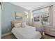 Light and airy bedroom with a queen-size bed and light blue walls at 3553 W 63Rd Ave, Denver, CO 80221