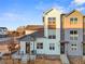 Modern two-story townhome with a gray and white exterior at 3553 W 63Rd Ave, Denver, CO 80221