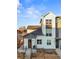 Modern two-story townhome with a gray and white exterior at 3553 W 63Rd Ave, Denver, CO 80221