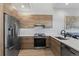 Modern kitchen with stainless steel appliances and light wood cabinets at 3553 W 63Rd Ave, Denver, CO 80221