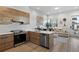 Open kitchen features stainless steel appliances and island with seating at 3553 W 63Rd Ave, Denver, CO 80221