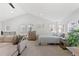 Loft bedroom with sitting area and wood dresser at 3553 W 63Rd Ave, Denver, CO 80221