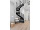 Modern black metal spiral staircase with wood flooring at 3553 W 63Rd Ave, Denver, CO 80221