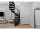 Modern spiral staircase with metal railing and hardwood floors at 3553 W 63Rd Ave, Denver, CO 80221