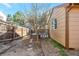 A cozy home backyard has a deck, gravel, some grass, and a wooden fence at 5106 Eagle Ct, Denver, CO 80239