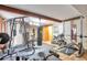 View of the home gym, featuring weight machines, free weights, and motivational wall art at 5106 Eagle Ct, Denver, CO 80239