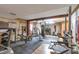 View of the spacious home gym with various machines and workout equipment over wood and black padded floors at 5106 Eagle Ct, Denver, CO 80239