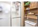 This bathroom offers a glass door shower, a white toilet, and shelving for storage at 5106 Eagle Ct, Denver, CO 80239