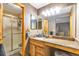This bathroom offers a glass door shower, a decorative mirror, and a single sink vanity at 5106 Eagle Ct, Denver, CO 80239