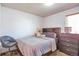 This bedroom has a gray bed set, wood floors, and a teddy bear on the bed at 5106 Eagle Ct, Denver, CO 80239