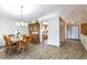 Elegant dining room featuring a wooden table, hutch, and modern chandelier at 5106 Eagle Ct, Denver, CO 80239