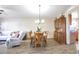 Open dining area features a wooden table set, hardwood floors and a decorative china cabinet at 5106 Eagle Ct, Denver, CO 80239
