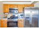 A gourmet kitchen with stainless steel appliances and matching refrigerator and oven at 5106 Eagle Ct, Denver, CO 80239