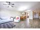 Bright living room shows open floor plan, hardwood style floors and access to the dining room at 5106 Eagle Ct, Denver, CO 80239