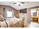Main bedroom showcases an ensuite bath, ceiling fan, and hardwood style flooring at 5106 Eagle Ct, Denver, CO 80239