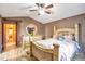 This primary bedroom features a wooden frame bed, a ceiling fan, and plenty of closet space at 5106 Eagle Ct, Denver, CO 80239