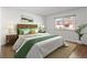 Tranquil bedroom featuring a cozy bed with stylish bedding, complemented by natural light from the window at 7755 E Quincy Ave # 203A2, Denver, CO 80237