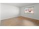 Bright bedroom with hardwood floors and a window at 7755 E Quincy Ave # 203A2, Denver, CO 80237