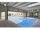 Bright indoor pool with clear water, large windows, and skylights, offering a year-round swimming option at 7755 E Quincy Ave # 203A2, Denver, CO 80237