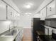 Modern kitchen features stainless steel appliances and white cabinetry in an open layout at 7755 E Quincy Ave # 203A2, Denver, CO 80237