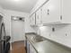 Well-maintained kitchen features white cabinets and stainless steel sink and appliances at 7755 E Quincy Ave # 203A2, Denver, CO 80237