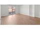 Spacious, bright living room with hardwood floors and a built-in bookshelf at 7755 E Quincy Ave # 203A2, Denver, CO 80237
