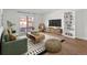 Bright living room featuring modern decor, stylish furniture, and a sliding glass door leading to a balcony at 7755 E Quincy Ave # 203A2, Denver, CO 80237