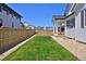 Lush backyard with a well-manicured lawn and wood fence, creating a private space at 1160 Spencer Pl, Erie, CO 80026