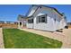 Back exterior with green lawn and gravel landscaping at 1160 Spencer Pl, Erie, CO 80026