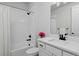 Bright bathroom featuring white subway tile surround, neutral walls and modern black fixtures at 1160 Spencer Pl, Erie, CO 80026