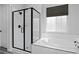 Modern bathroom featuring glass enclosed shower, soaking tub, and white tile at 1160 Spencer Pl, Erie, CO 80026