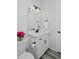 Bright bathroom featuring white cabinetry, neutral walls and floors, and modern black fixtures at 1160 Spencer Pl, Erie, CO 80026