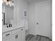 Bright bathroom featuring white cabinetry, neutral walls and floors, and modern black fixtures at 1160 Spencer Pl, Erie, CO 80026