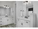 Modern bathroom with double vanity sinks, white cabinets, and black hardware at 1160 Spencer Pl, Erie, CO 80026