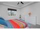 Bright bedroom with tray ceiling, ceiling fan, and large window at 1160 Spencer Pl, Erie, CO 80026