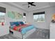 Bright bedroom with tray ceiling, ceiling fan, and colorful bedding at 1160 Spencer Pl, Erie, CO 80026