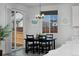 Bright dining area with black table and sliding glass door with backyard views at 1160 Spencer Pl, Erie, CO 80026