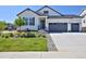 Charming home with modern white siding, dark trim, and a two-car garage, plus a lovely manicured front yard at 1160 Spencer Pl, Erie, CO 80026