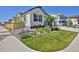 A beautifully landscaped front yard complements this home's modern exterior, plus lush green lawn and mature landscaping at 1160 Spencer Pl, Erie, CO 80026