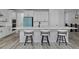 This stylish kitchen features a large island with seating, perfect for entertaining, as well as designer appliances at 1160 Spencer Pl, Erie, CO 80026