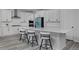 This stunning kitchen boasts sleek, white cabinets, stainless steel appliances, and an oversized quartz island at 1160 Spencer Pl, Erie, CO 80026