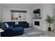 Cozy living room features a blue sectional sofa, fireplace, and large window at 1160 Spencer Pl, Erie, CO 80026