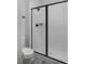 Modern shower featuring white tile with sleek black trim and hardware at 1160 Spencer Pl, Erie, CO 80026