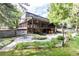 Expansive backyard boasting a stone patio, lush lawn, mature trees, and inviting outdoor seating areas at 730 Crescent Ln, Lakewood, CO 80214