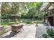 Lush backyard featuring a stone patio, a well-manicured lawn, and a charming gazebo at 730 Crescent Ln, Lakewood, CO 80214