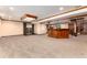 Expansive finished basement with a classic bar area and a spiral staircase, perfect for entertaining at 730 Crescent Ln, Lakewood, CO 80214