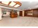 Finished basement featuring a stylish bar area, custom shelving, and a unique spiral staircase at 730 Crescent Ln, Lakewood, CO 80214