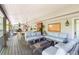 Spacious covered deck with ample seating, a stylish fire pit, and outdoor dining space, ideal for gatherings at 730 Crescent Ln, Lakewood, CO 80214